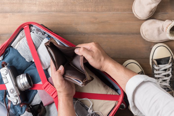 Empty wallet in the hand man on Travel accessories background